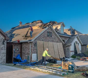 Roofer repairing shingles