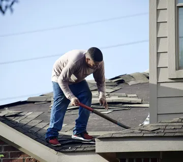 Roofer documenting storm damage